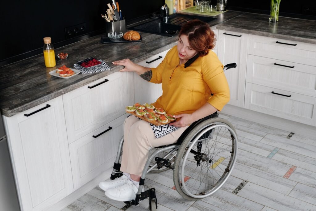 Cuisine accessible utilisée par une femme en fauteuil roulant